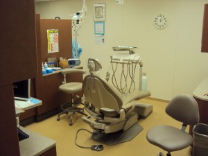 A dentist 's office with an open door to the room.